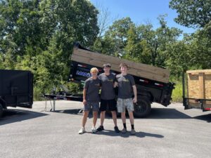 The Young Bucks Junk crew standing with their large empty dump trailer in Shawnee, KS, ready for a job.