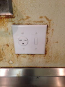 A 240V electrical outlet and light switch combination plate installed on a wall by RightWay Electric RI in Providence, RI.