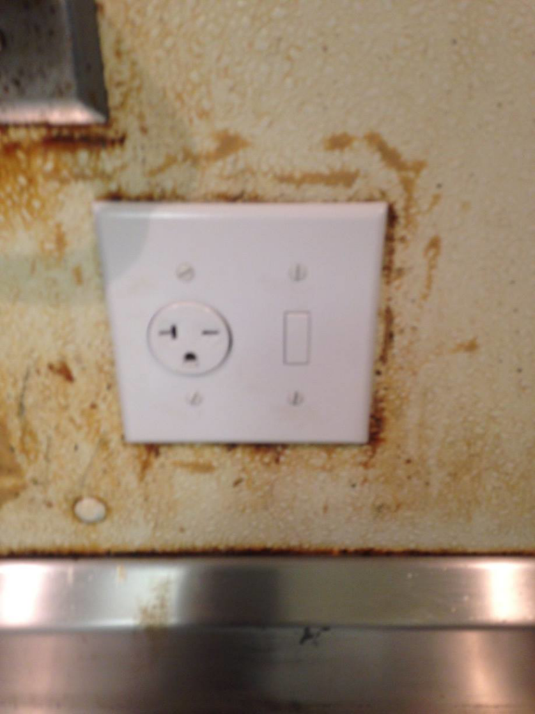 A 240V electrical outlet and light switch combination plate installed on a wall by RightWay Electric RI in Providence, RI.