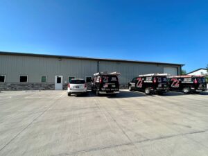 The exterior of the 72 Degrees business office with multiple HVAC service vans parked outside in Ankeny, IA.
