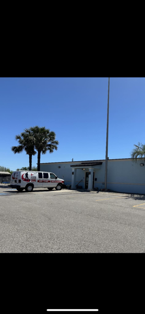 The A+ Floor Care service van parked outside a commercial building for a carpet cleaning job in Corpus Christi, TX.