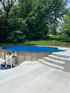 An above-ground pool with its filter system, maintained by Fox Pools of Evansville Inc in Evansville, IN