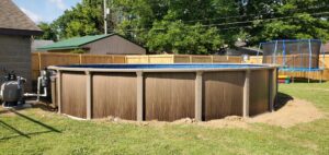 An above-ground pool installation with pump and filter system by Firemaster in Oklahoma City, OK