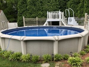 An above-ground pool with a surrounding deck and steps, installed by Firemaster in Oklahoma City, OK