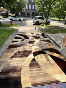 Large abstract patterned area rug laid out after cleaning by PROlific Cleaning Services LLC in Indianapolis, IN.