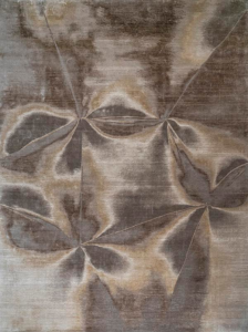 An abstract patterned rug in grey and brown tones, available at Organic Looms in Scottsdale, AZ