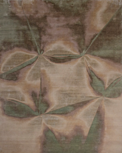 An abstract patterned rug in brown and green tones, available at Organic Looms in Scottsdale, AZ