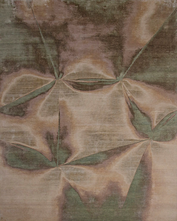 An abstract patterned rug in brown and green tones, available at Organic Looms in Scottsdale, AZ