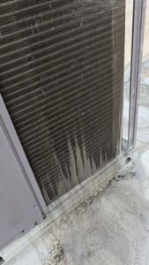 An outdoor AC unit coil being cleaned with foaming cleaner by Quantum Cooling & Heating in Mesa, AZ.