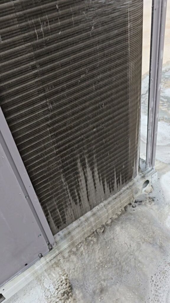 An outdoor AC unit coil being cleaned with foaming cleaner by Quantum Cooling & Heating in Mesa, AZ.