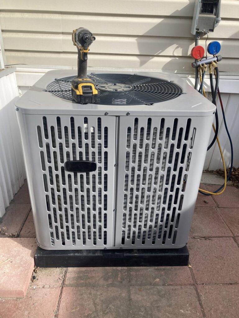 An outdoor AC condenser unit being serviced with refrigerant gauges by LUCAS Heating And Air LLC in Salt Lake City, UT.