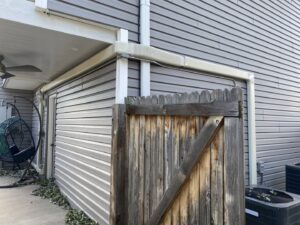 An outdoor AC unit with a newly installed line set cover along the side of a house by Primary Air Home Services in Aurora, CO.