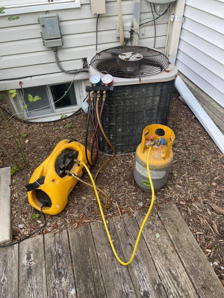 An HVAC technician performing an AC refrigerant recharge service for Wilcox Services in Temple Hills, MD.