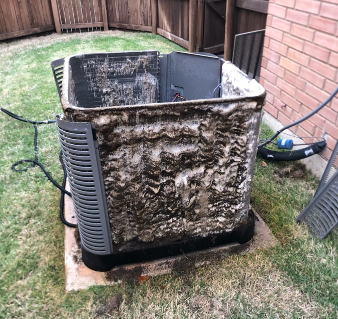 AC unit coils with heavy dirt and mold buildup, indicating a need for cleaning by CLM Mechanical in Dallas, TX