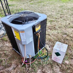 An outdoor AC unit undergoing diagnostic service with gauges connected by Faith Heat and Cool in West Monroe, LA