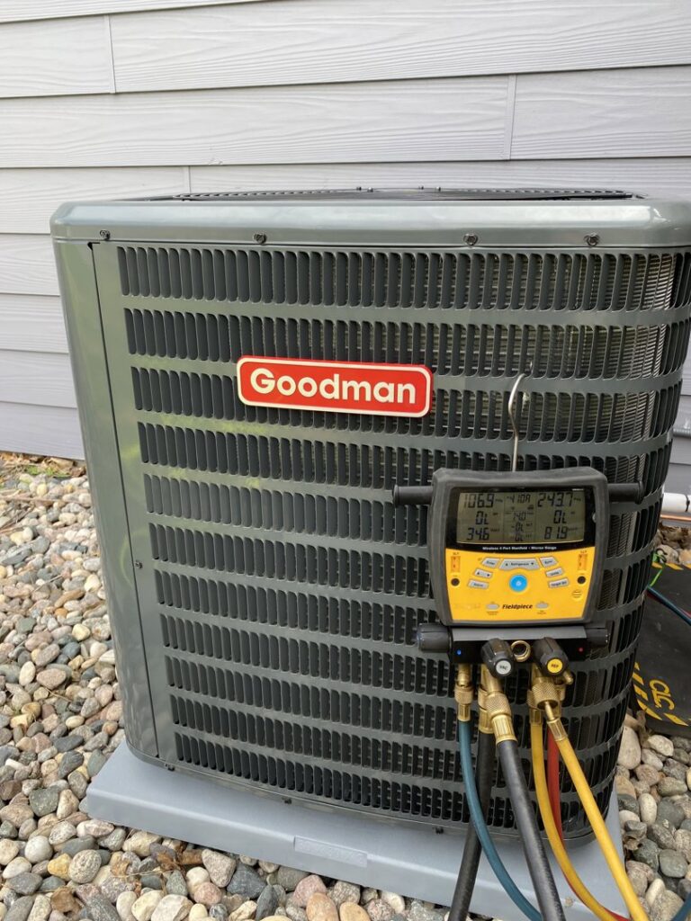 A Goodman outdoor AC unit undergoing diagnostic service with gauges connected by True Comfort Heating and Cooling in Sherwood, AR.