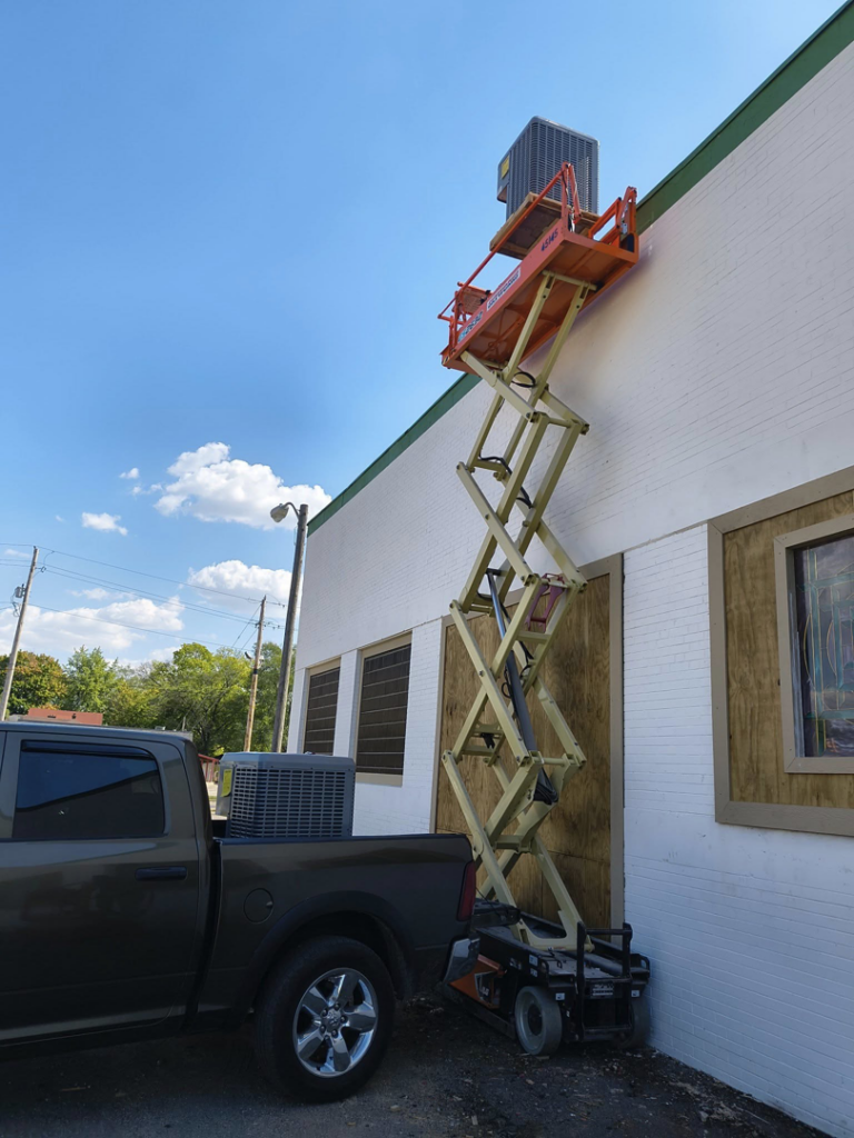 An AC unit on a scissor lift and in a truck bed, ready for installation by Aaron's Affordable Ac in Indianapolis, IN.