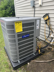 An outdoor Comfort-Aire AC unit being serviced or installed by West Mechanical in Summerville, SC, with gauges connected.