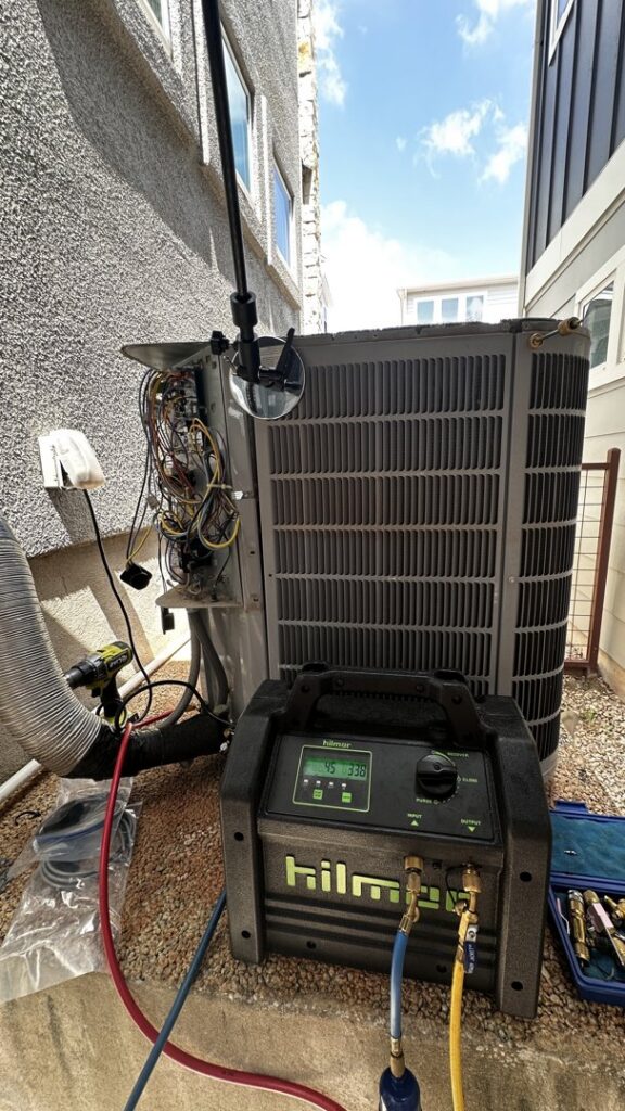 An outdoor AC unit undergoing refrigerant service with a vacuum pump by Bree HVAC Contractor in Cedar Park, TX.