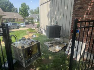 An old AC unit removed and a new one installed by Guy's Heating And Cooling during a replacement job in Kansas City, MO.