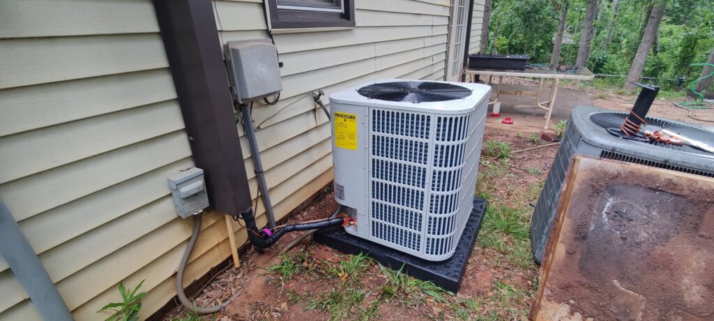 A new outdoor air conditioning unit installed next to an old unit by Icy Hot HVAC in Spartanburg, SC