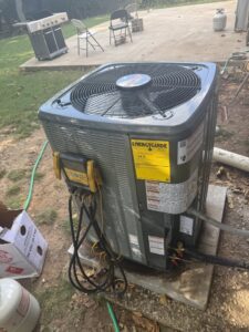 An outdoor air conditioning unit being serviced or installed with gauges attached by AirTech Solutions LLC in Broken Arrow, OK.