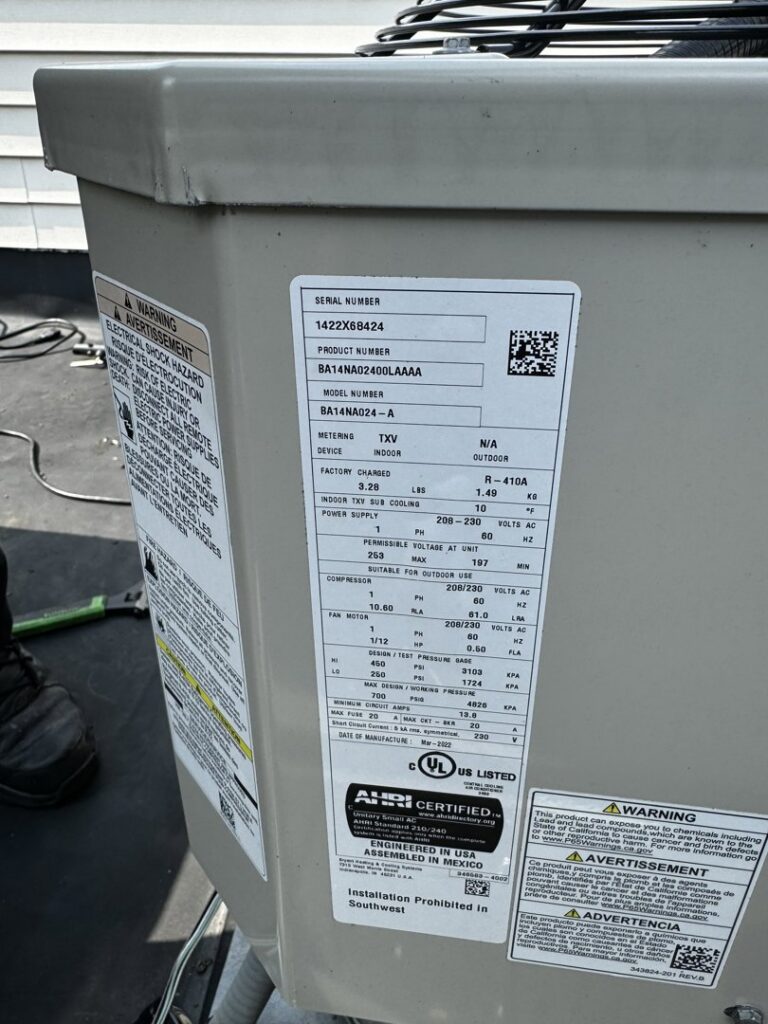 A close-up of an AC unit's specification label, showing model and serial numbers, for service by Simply Home Service in Gaithersburg, MD.