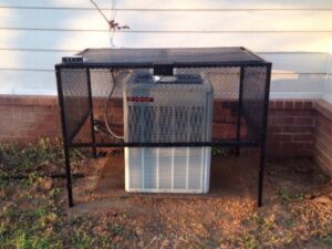 An outdoor AC unit with a protective cage installed by Brimhall Maintenance Services in Cordova, TN