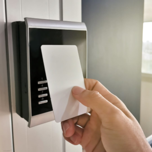 A hand using an access control card reader, installed by Access Hardware Inc in Honolulu, HI