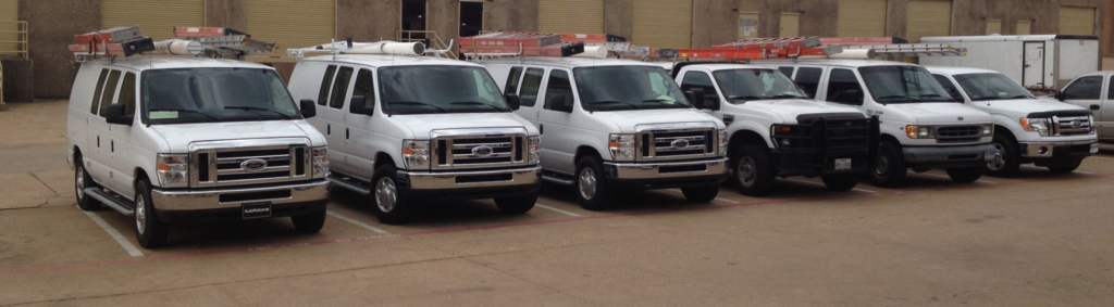 A line of AccuTex Electric service vans and trucks parked, ready for electrical work in Fort Worth, TX.