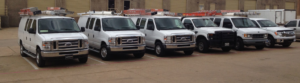 A line of AccuTex Electric service vans and trucks parked, ready for electrical work in Fort Worth, TX.