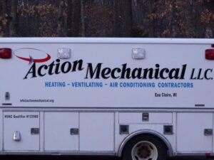 A white service truck for Action Mechanical LLC, an HVAC contractor in Eau Claire, WI, with business branding.