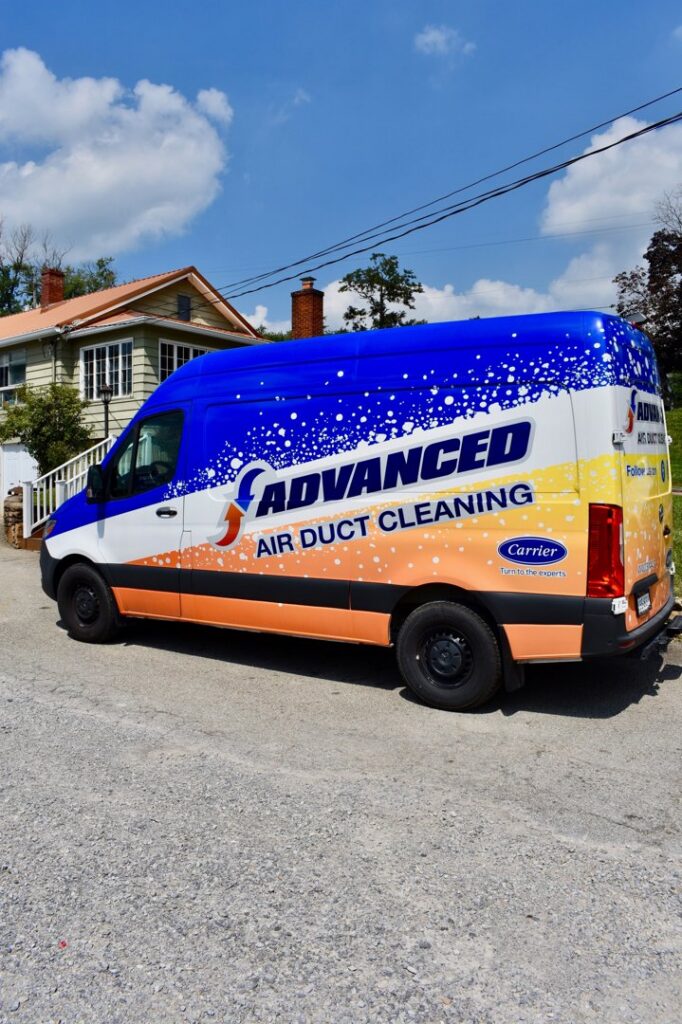 An Advanced HVAC and Plumbing air duct cleaning service van parked on a street in Morgantown, WV.