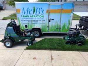 Professional lawn aeration equipment and a branded trailer from Mr. B's Lawn Aeration parked in Lafayette, IN.