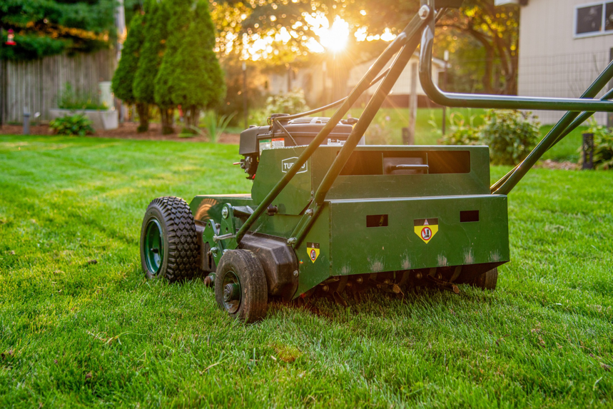A close-up view of a professional aerator machine working on a lawn by Aeration Pros Lawn Care LLC in McFarland, WI.