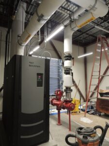 An AERCO Benchmark boiler unit with associated piping installed by Central Consolidated in Wichita, KS