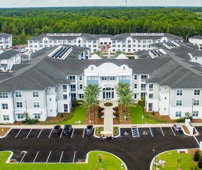 Aerial view of an apartment complex with solar panels on the roof, installed by Performance Electrical Contracting Inc. in Jacksonville, FL