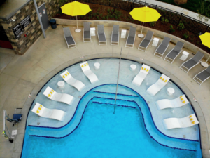 An aerial view of a resort-style pool and lounge area designed by Midwest Custom Pools, LLC in Lawrence, KS.