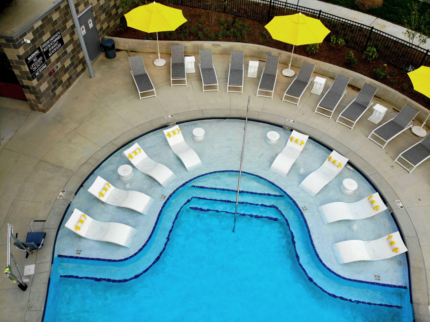 An aerial view of a resort-style pool and lounge area designed by Midwest Custom Pools, LLC in Lawrence, KS.