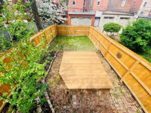 An aerial view of a backyard featuring a newly installed wood privacy fence and deck by Exterior Experience LLC in St. Louis, MO.