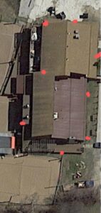 An aerial view of buildings with red markers indicating pest control treatment or inspection points by You Betcha Pest Control & Solutions LLC in Rochester, MN.