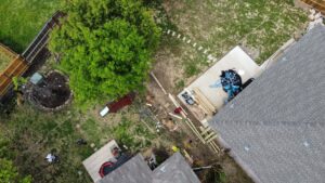 An aerial view of a backyard fencing construction site with lumber and materials, managed by Reliable Texas Fencing in Fort Worth, TX.