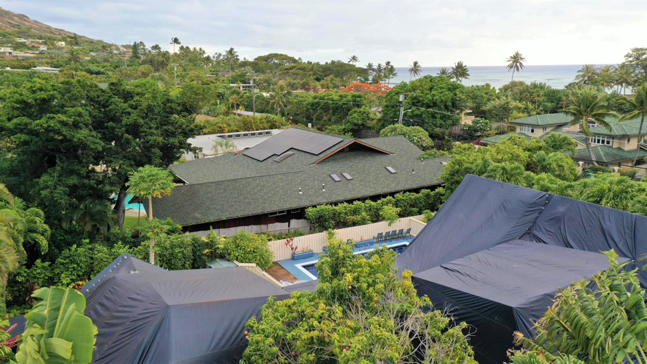 An aerial view of a house partially tented for termite fumigation by Oahu Termite and Pest Control in Pearl City, HI.