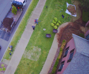 An aerial view of a King Lawn Care team performing a landscaping job with a leaf blower in Alexandria, VA.