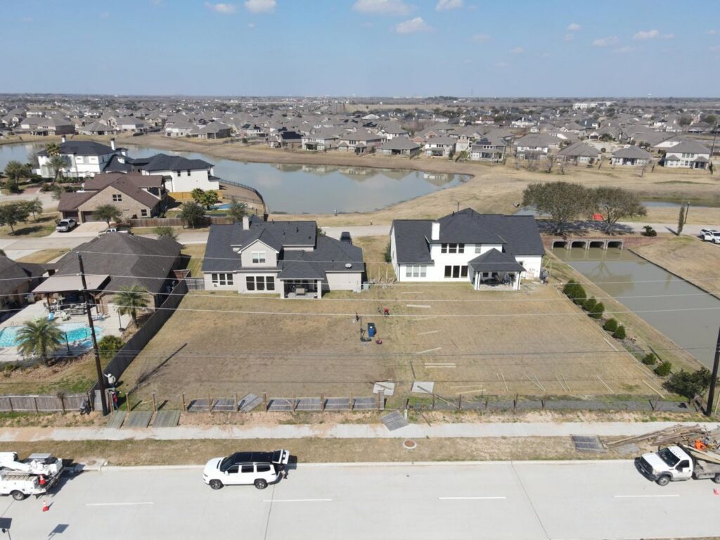An aerial view of a new fence project in a residential development, showing fence materials laid out by Fence Builders of Houston, TX.