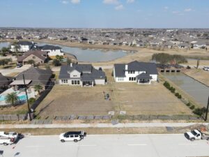 An aerial view of a new fence project in a residential development, showing fence materials laid out by Fence Builders of Houston, TX.