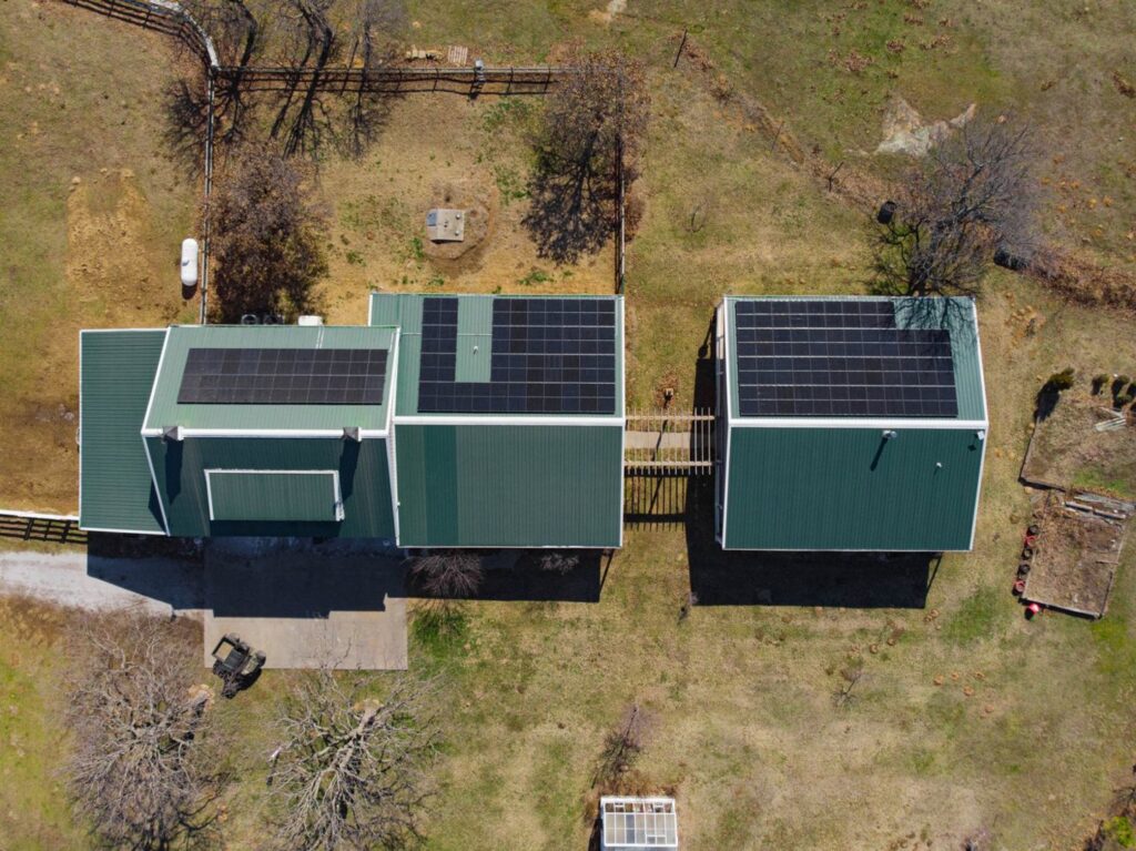 An aerial view of a building with multiple solar panel installations completed by Premier Power in Edmond, OK.