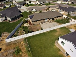 An aerial view of a white vinyl fence enclosing a residential backyard by Sublime Fencing LLC in North Logan, UT.