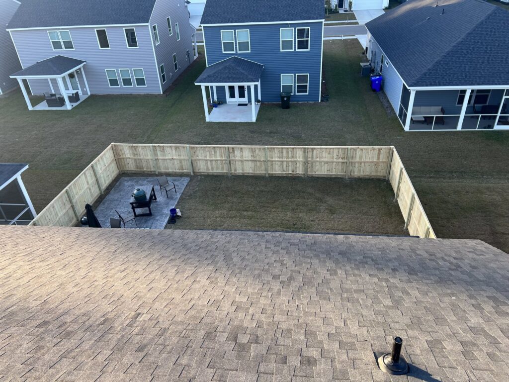 An aerial view of a newly installed wood privacy fence enclosing a backyard by Charleston Fencing Services in Moncks Corner, SC.