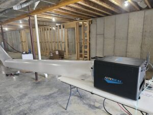 Aeroseal duct sealing equipment connected to ductwork in an unfinished basement by Aces of Air Inc. in Georgetown, KY.